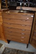 A mid century chest of seven drawers having a G Plan style design