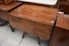 An antique mahogany fold out tea or breakfast table having one under drawer and one false