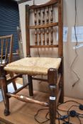 A traditional rush seated spindle back dining chair