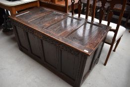 A period oak four panel kist having carved detail to frieze, width approx. 126cm, depth 63cm, height