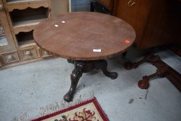 A low tripod table base with amalgamated wooden top