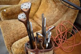 A selection of vintage golf clubs in bag