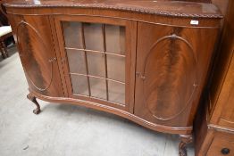 An early 20th Century serpentine front display cabinet