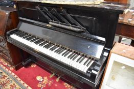 A traditional upright piano having ebonised case, labelled and impressed for Duck , Son & Pinker