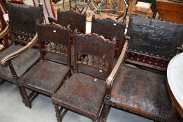 A set of six (four plus two) period style oak frame chairs having embossed leather detailed seats
