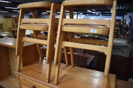 A set of four mid century beech wood stackable kitchen utility stools