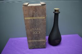 A bottle of Otard XO Cognac, 70cl 40% vol, cork damaged, level sounds to be half full, in wooden