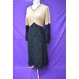 A 1930s black and taupe lace dress having silk lining and belted waist.