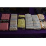 An assortment of vintage and retro bed sheets in original packaging.