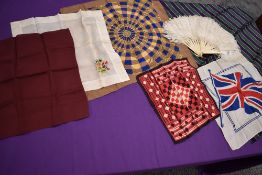 An early 20th century ostrich feather fan and a selection of handkerchiefs including embroidered