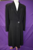 A 1940s ladies black wool crepe Malbeck coat having pleated details to back and single button