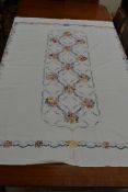 A very large vintage linen cloth or bed throw having extensive floral cross stitch design