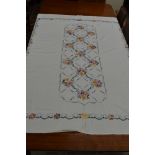 A very large vintage linen cloth or bed throw having extensive floral cross stitch design