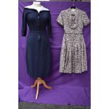 A vintage 1950s St Michaels tea dress with floral pattern and belt and similar navy blue dress