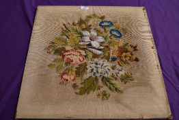 A Victorian wool embroidered panel having floral pattern and bead work detailing.