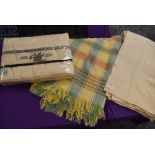 Three vintage wool blankets including one in original packaging and green and yellow checked