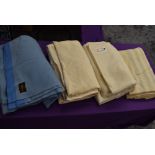 A collection of vintage wool blankets including blue blanket and CC41 labelled utility blanket.