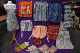 A lovely collection of aprons and overalls, some having original packaging and a lot appearing