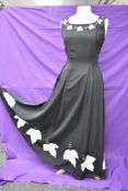 A vintage 1950s evening gown in black having cream ivy appliqué pattern and side metal zipper,