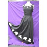 A vintage 1950s evening gown in black having cream ivy appliqué pattern and side metal zipper,