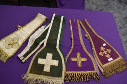 Four vintage priests stoles having fringed edges.