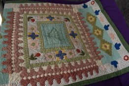 A large retro patchwork quilt using a variety of colourful fabrics.