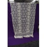 A vintage French tulle curtain with heavy crotched work and fringing.