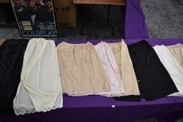 A selection of vintage ladies nylon slips and underskirts.