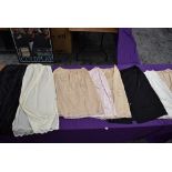 A selection of vintage ladies nylon slips and underskirts.