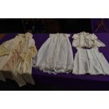 An antique wool christening shawl or similar,a tulle babies gown and more.