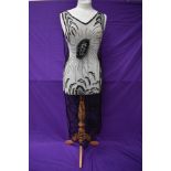 A superb example of a 1920s tulle tabard dress having extensive and intricate beading and sequin