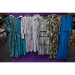 An assortment of vintage and retro Ladies clothing in a variety of colours,styles and eras including