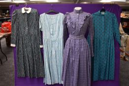 A collection of vintage and retro Laura Ashley dresses in a mixture of colours and styles.