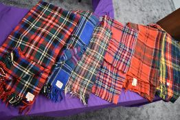 Seven vintage tartan travel rugs, one still having tags and original receipt.very good condition.