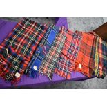 Seven vintage tartan travel rugs, one still having tags and original receipt.very good condition.