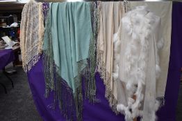 A collection of vintage and antique shawls including mint green fringed shawl,another of silk having
