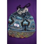 An extensively beaded draw string evening bag having a variety of colourful patterns interwoven with