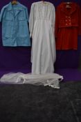 A mixture of ladies vintage clothing including wedding dress.