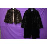 A black 1940s fur coat having pom pom fastenings and a 1940s brown mole skin cape.