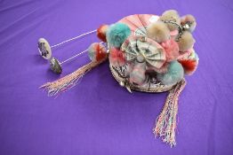 A vintage oriental cap with pom poms,bells, and metallic embroidery with mirrors, also included