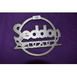 A reproduction cast metal commercial radiator badge for Seddon