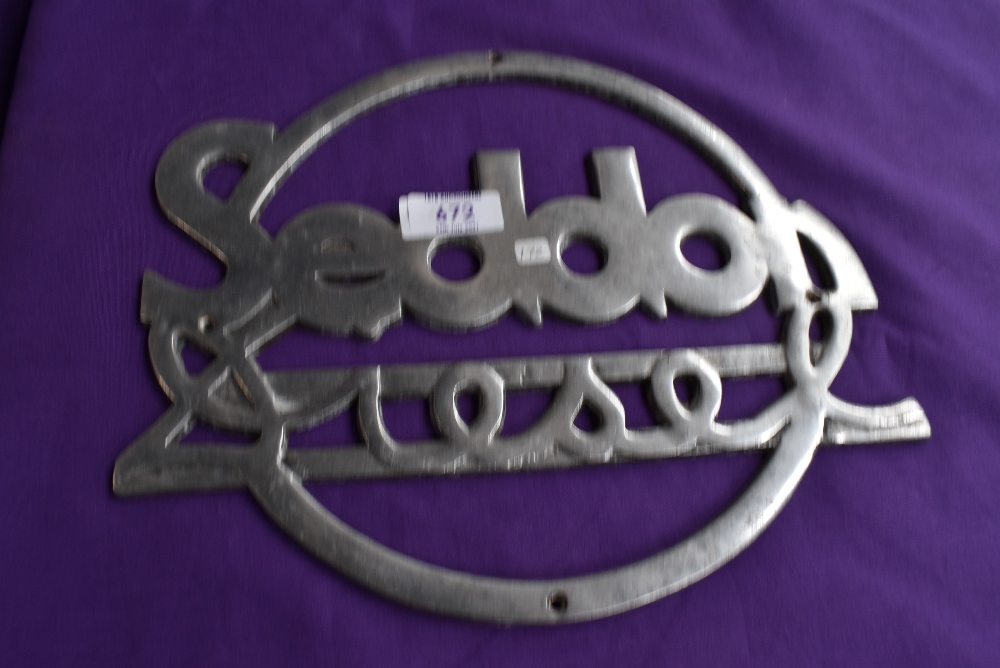 A large original Seddon diesel radiator badge.