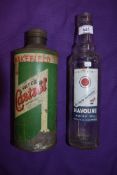 A Castrol oil tin and a Havoline motor oil bottle.