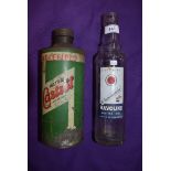 A Castrol oil tin and a Havoline motor oil bottle.