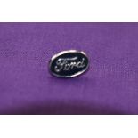 A Ford lapel badge.