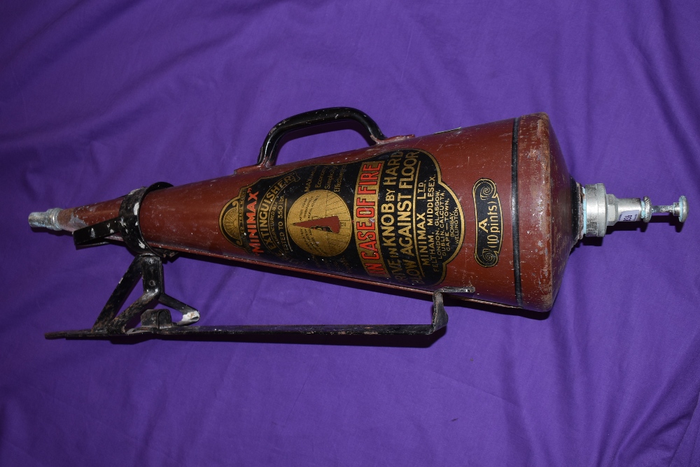 A vintage conical shaped fire extinguisher the Minimax with wall bracket