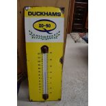 An enamel garage advertising sign thermometer for Duckhams Oil