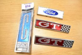 Four vintage motor car engine badges, a Ford Cortina, two GT and a Ford