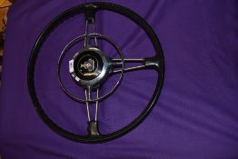 A vintage two fork steering wheel for Rover cars having horn push