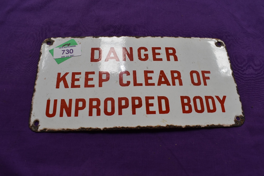 A vintage garage sign for Danger Keep Clear of Unpropped Body